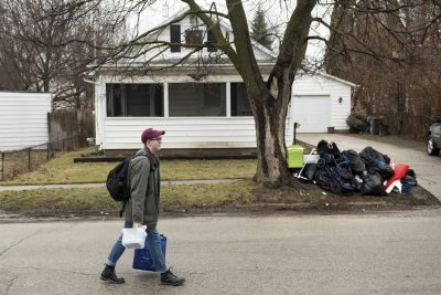 A Virginia Tech student collecting water samples on the streets of Flint, Michigan. 