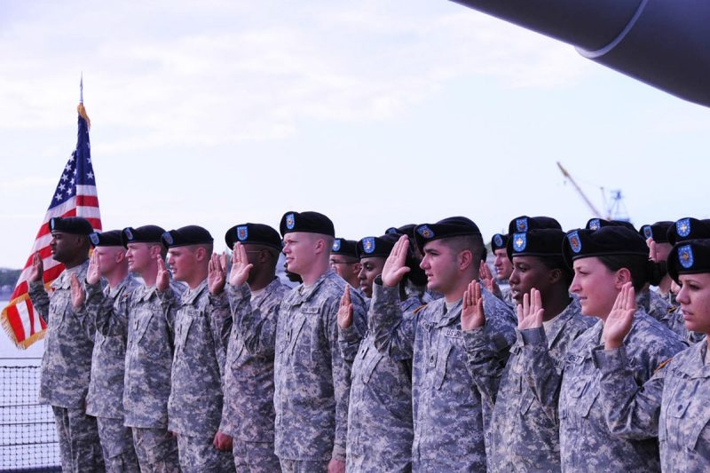 Soldiers raise their right hands to take the Oath of Re-enlistment.