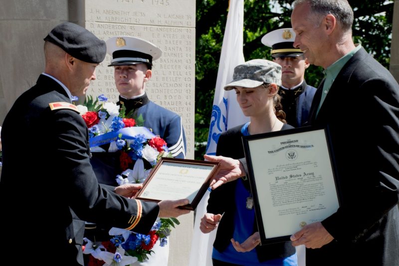 Col. Kevin Milton, at left, presents the late 2nd Lt. Joseph DeWitt’s certificates to family members Rachel DeWitt, his sister, and Brendon DeWitt, his father