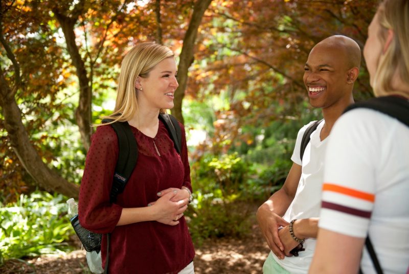 A male and female student engage in conversation on Virginia Tech's campus
