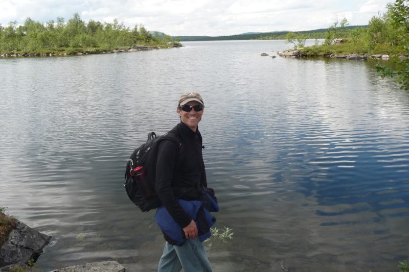 Kris Wernstedt backpacking by river