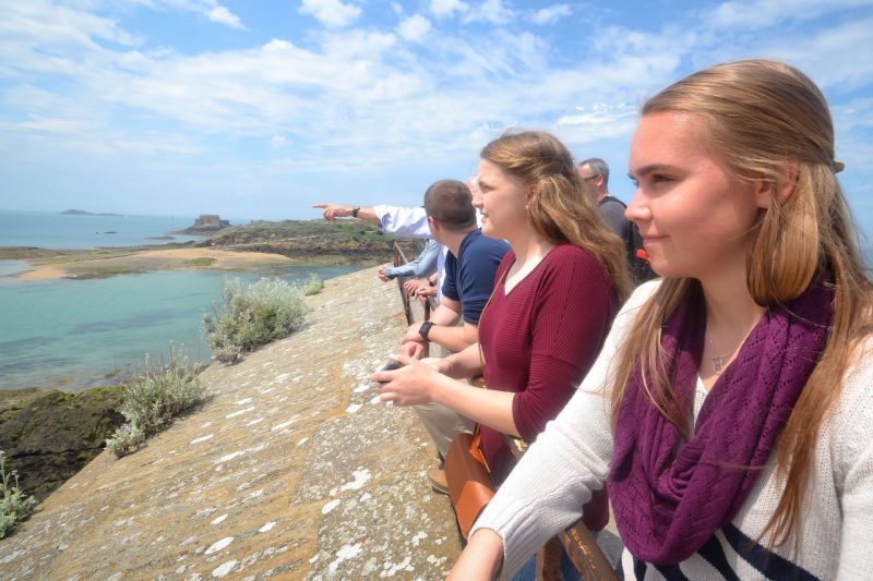 Cadets Noel Sheaffer, second from right, and Grace Spencer at far right, look over the beach in Normandy, France.