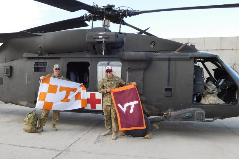 U.S. Army Capt. and Virginia Tech alumnus Travis Taggart, at right, and Capt. Trevor Joseph, a Tennessee alumnus, in front of a UH-60 Medevac helicopter.