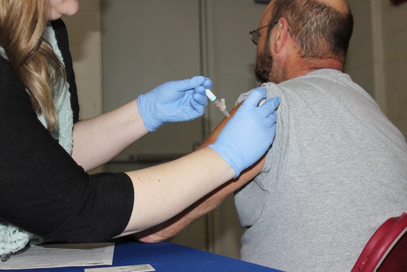 An employee receives a flu shot at the benefits and wellness fair.