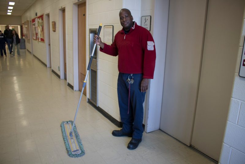 An image of housekeeper Michael Calfee mopping the floors of Cheatham Hall.