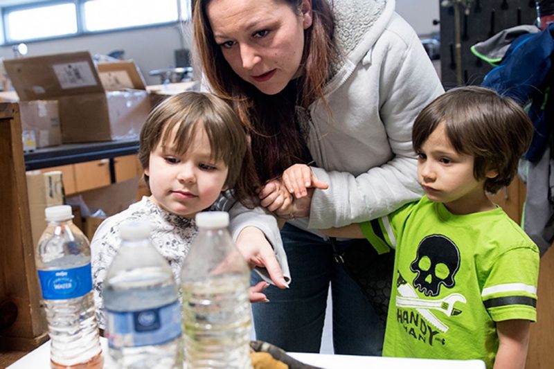 Lee-Anne Walters with twin sons Garrett (left) and Gavin (right), looking at some of their  home's samples in one of Marc Edwards' labs. 