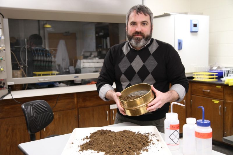 Strickland with soil sample in lab