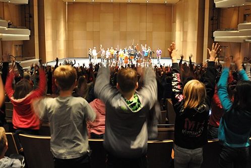 Photograph of children at a performance at Virginia Tech's Moss Arts Center.