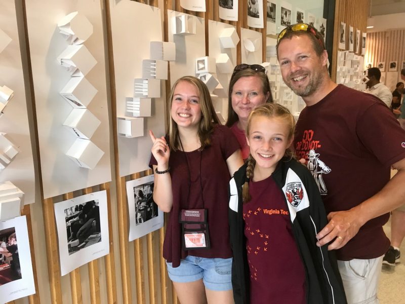 Brianna Laverty proudly shows off her work to her family, including dad, Kevin (right), a 1998 mechanical engineering alumnus.