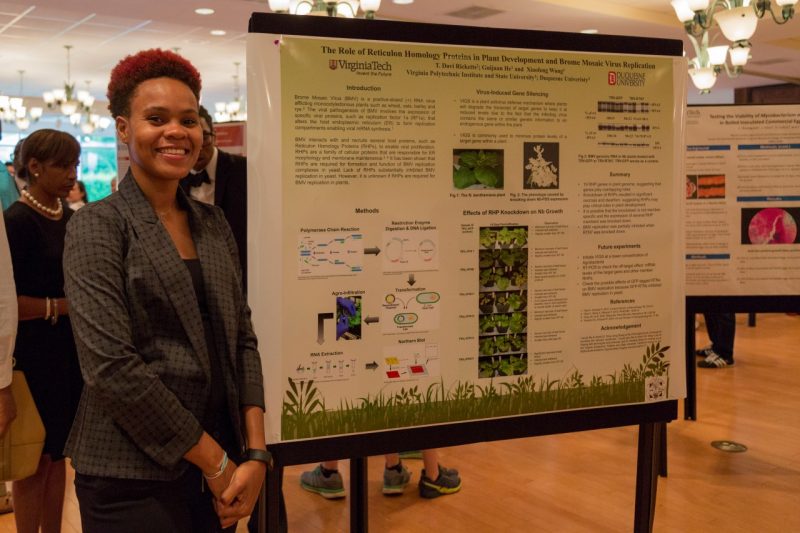 Tiffany Ricketts of Duquesne University poses for a photo with her summer research poster. Ricketts and 40 other interns worked on research for 10 weeks through the Multicultural Academic Opportunities Program’s Summer Research Internship.