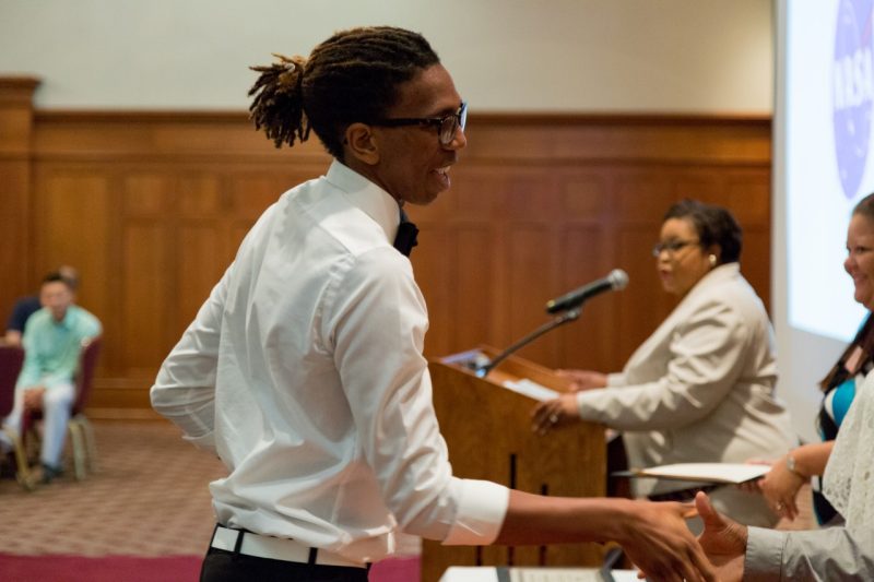 Ryan Littlejohn of Virginia State University shakes hands after receiving a certificate for completing MAOP’s 10-week summer research internship.