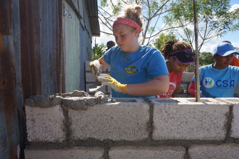A student helps to build an outdoor latrine in the Dominican Republic.