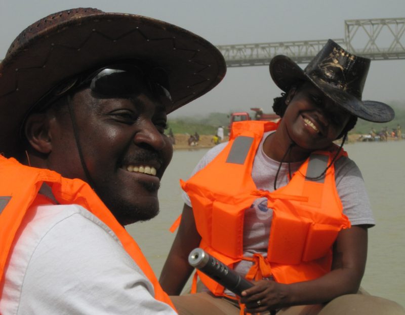 Gifty Anane-Taabeah and advisor Emmanuel Frimpong measure water quality and sample for fish.