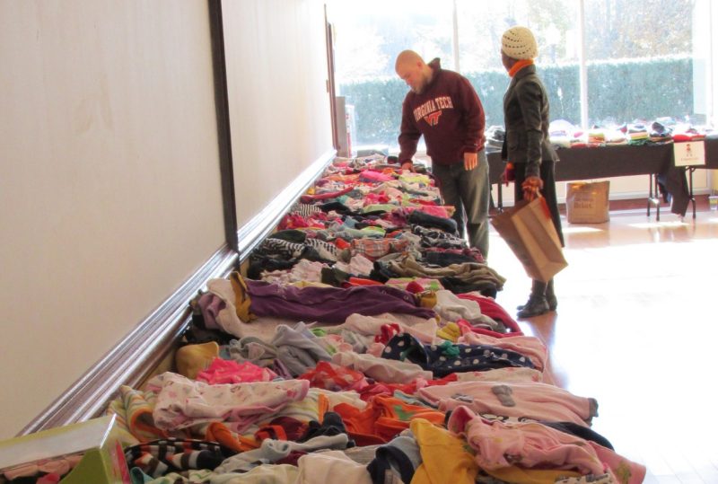 Two students looking at clothing and other items at Little Hokie Hand-me-down