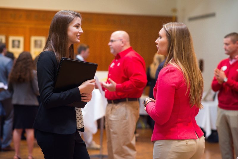 Carolyn Dixon (left), a junior studying marketing and management, chats with a Target representative during a networking session at the Student Leadership Conference in January.