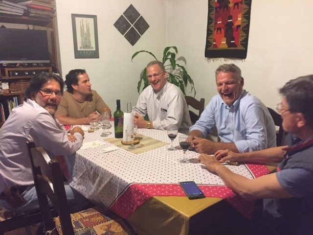 Grant and Gerrard, center, enjoy dinner with friends at a home in Uruguay.