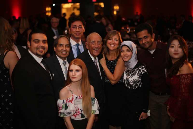 Howard Feiertag poses with eight other guests, who include graduate students, professor Mahmoud Khan, and department head Nancy McGehee.