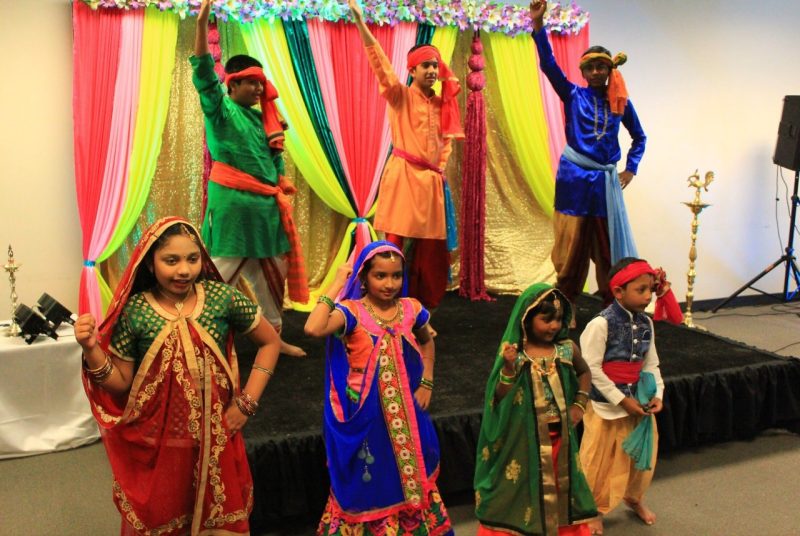 Seven children in traditional Indian dress perform a dance at the event.