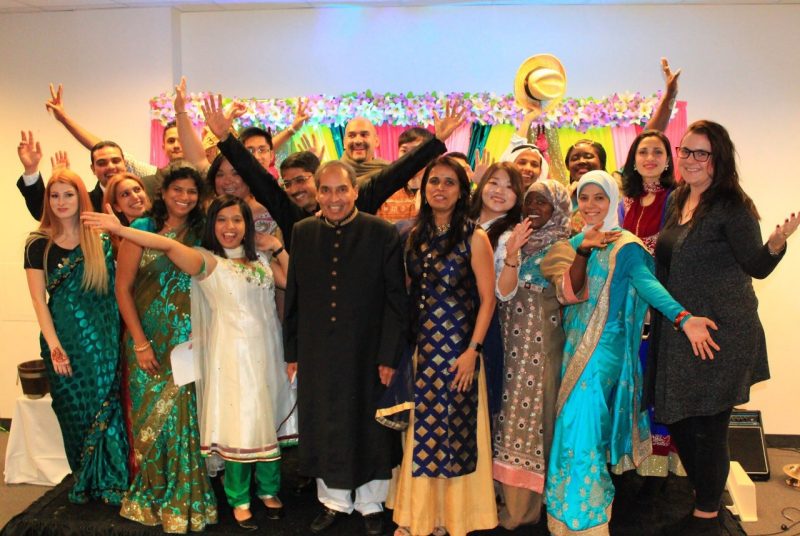 Mahmood Khan (front row center) poses with a large group of some of the students and other guests at the event.