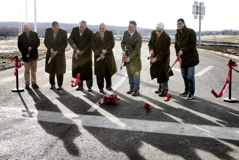 This photo shows a group of people cutting the ribbon at the new 460 Southgate interchange.