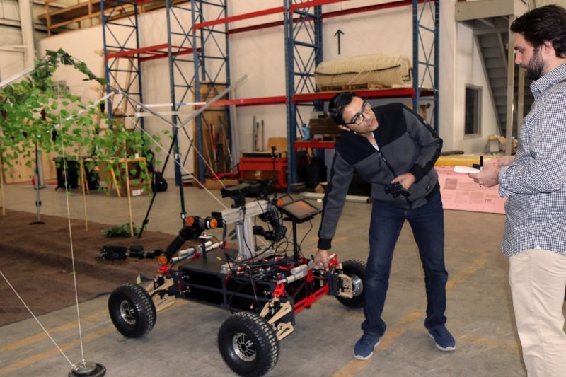 Student Tamer Attia demonstrates  wheeled humanoid robot for a Roanoke Times reporter 