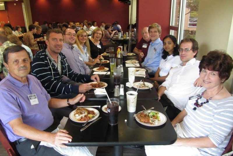 John and Susan Muffo (front), enjoy a restaurant meal with eight others, who include members of a team from the University of Trento, Italy, during at the 2015 Global Entrepreneur Challenge.