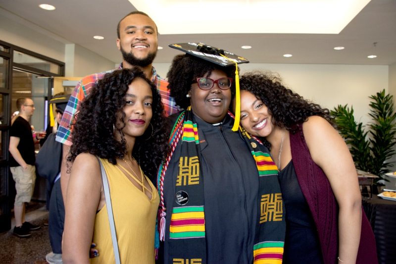 Ginai Seabron poses with three friends after her graduation ceremony