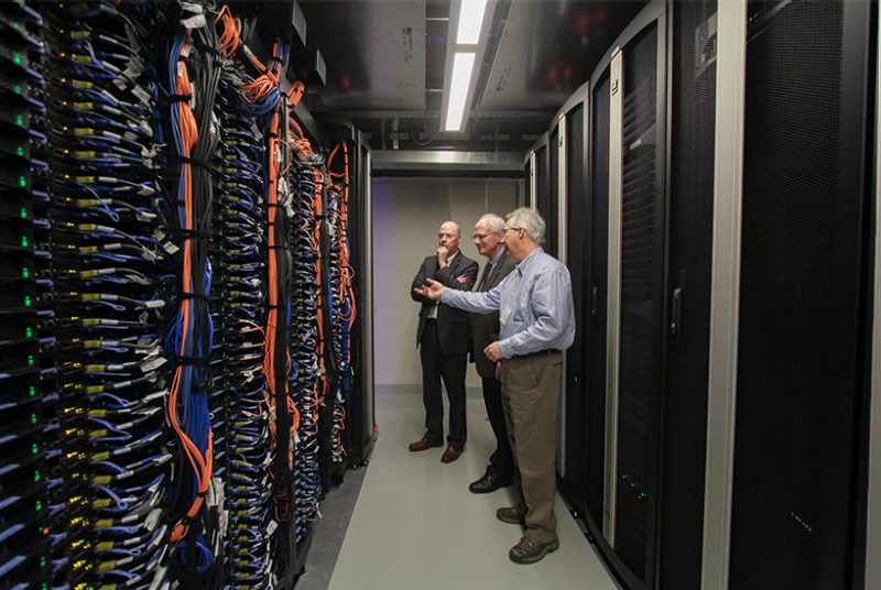 Director of IT shows visitors the inner workings of the compute cluster.