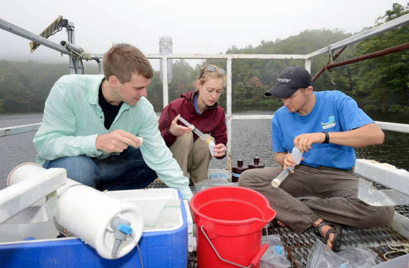 Researchers take water samples. 