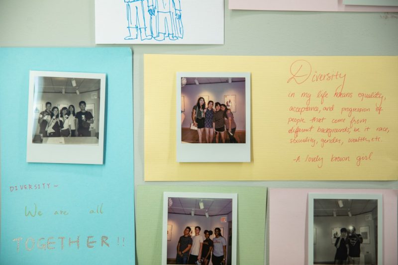 Polaroid photos and handwritten reflections on diversity.