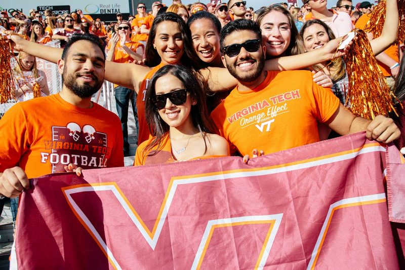 Students wearing Virginia Tech gear at a football game