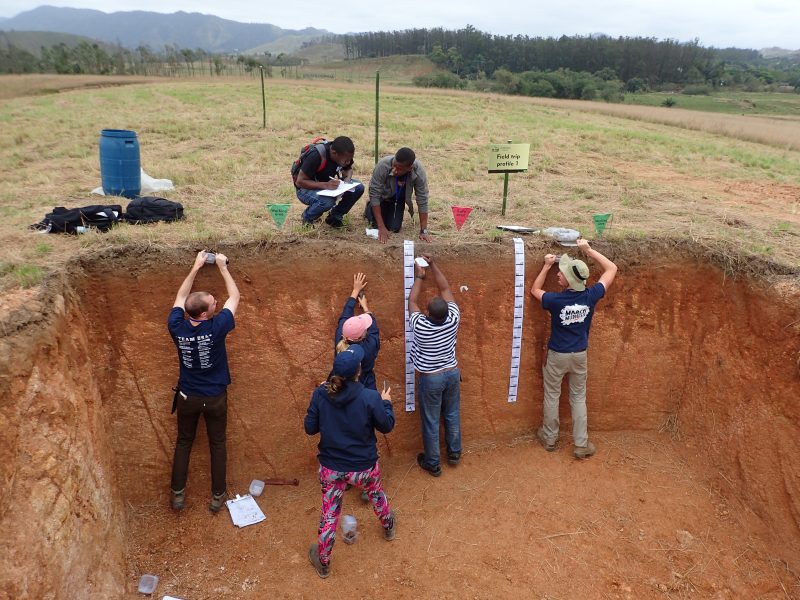 Students from the U.S. team 2 and Great Britain practice judging soils in Seropédicia Brazil at the Third International Soil Judging Contest.