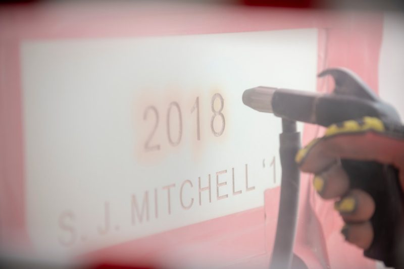 S.J. Mitchell '18 is engraved on the Ut Prosim Pylon.