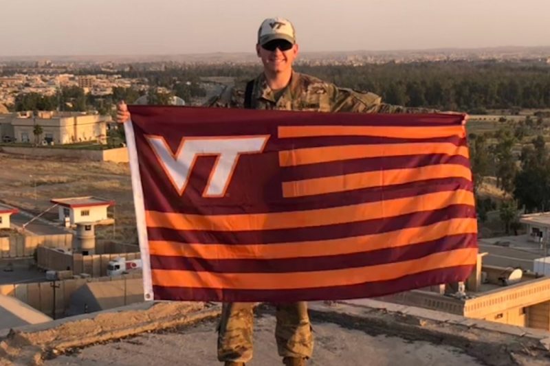 U.S. Army 1st Lt. Zachary Bird holds a Hokie flag.