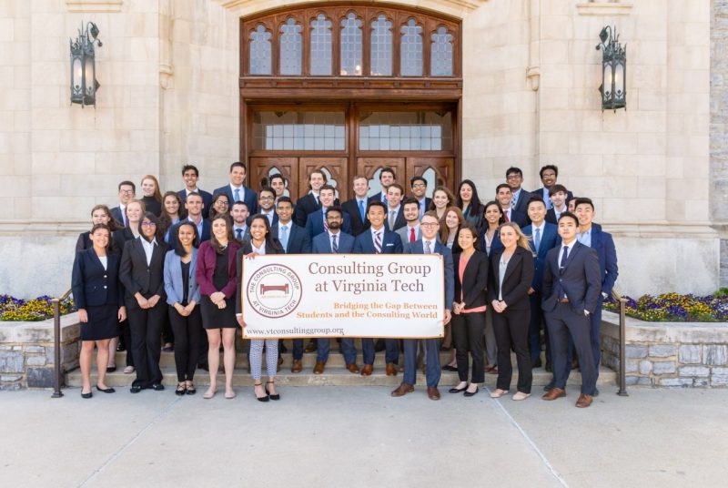 Members of the Consulting Group at Virginia Tech gather outside Burruss Hall for a group picture.