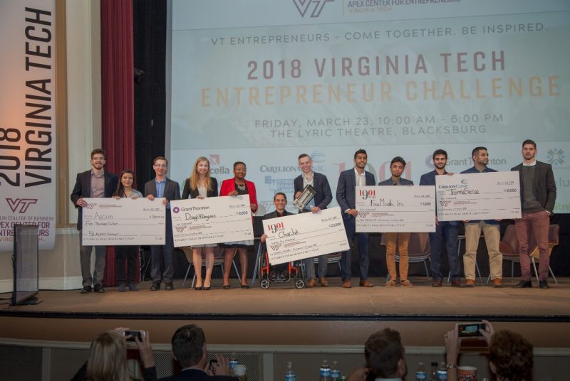 The winners of the 2018 Virginia Tech Entrepreneur Challenge pose with their checks on stage at the Lyric