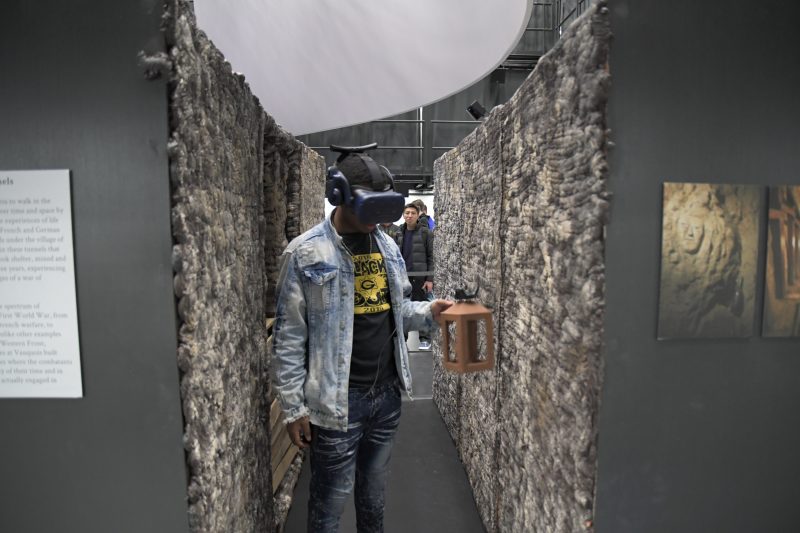 Person walking through tunnel with VR goggles