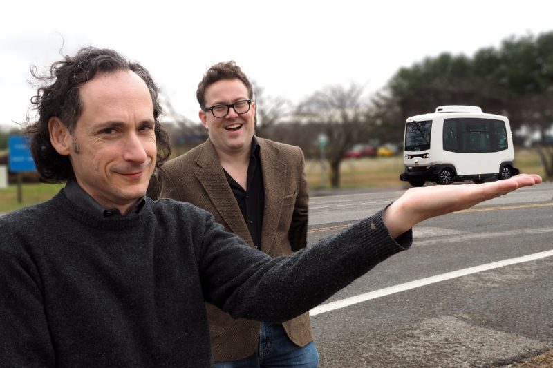 Saul Halfon (left) and Lee Vinsel playfully consider a low-speed autonomous shuttle undergoing testing at the Virginia Tech Transportation Institute.