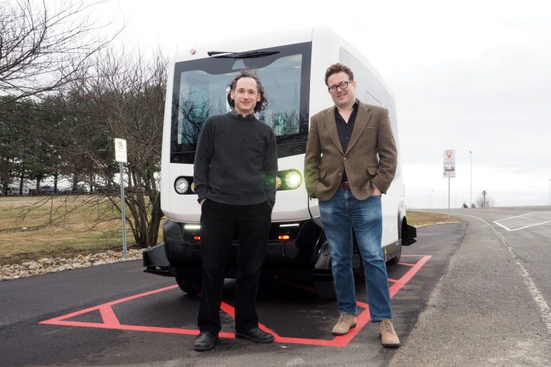 Saul Halfon (left) and Lee Vinsel stand in front of a low-speed autonomous shuttle undergoing testing at the Virginia Tech Transportation Institute.