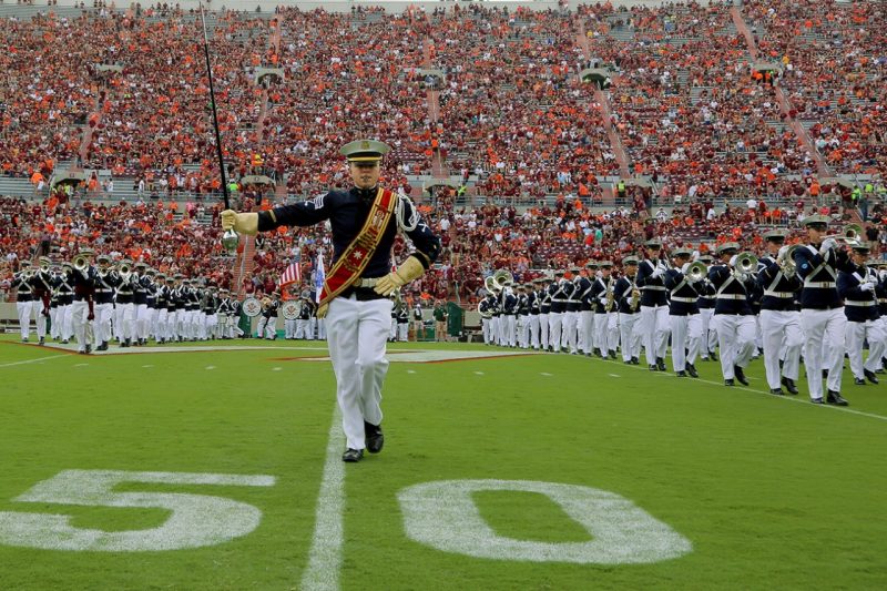 Parker Treubert, a senior majoring in aerospace engineering, leads the Highty-Tighties during a performance in Lane Stadium..