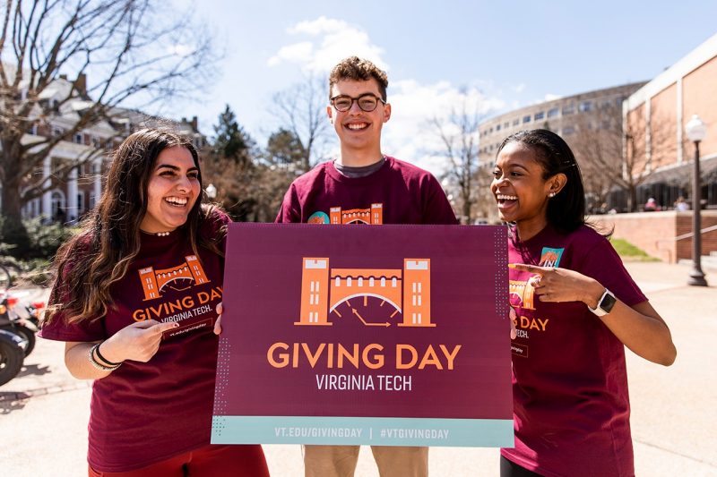 Virginia Tech students holding Giving Day sign
