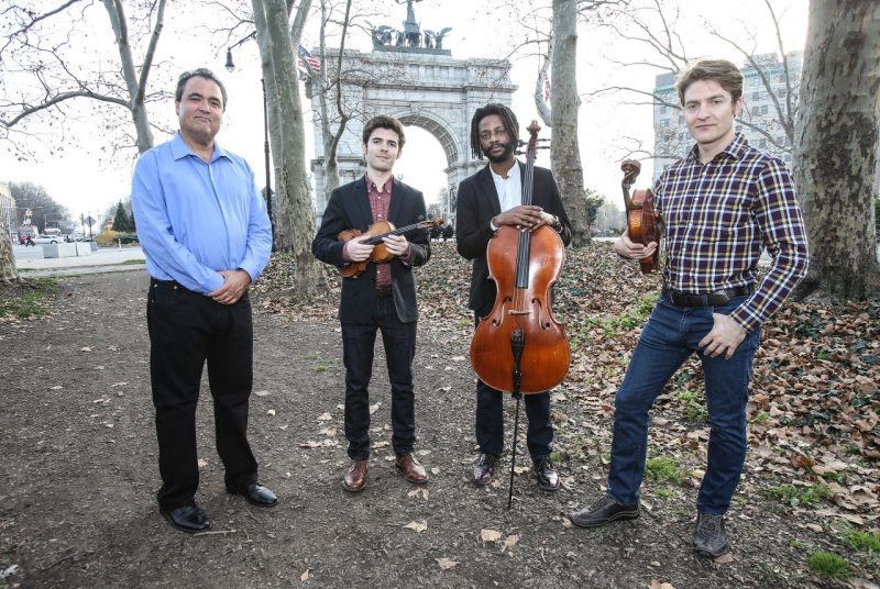 Members of the Turtle Island Quartet pose outside with their instruments.
