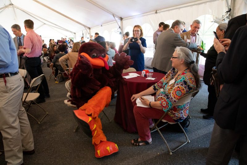 The HokieBird chats with celebration attendees