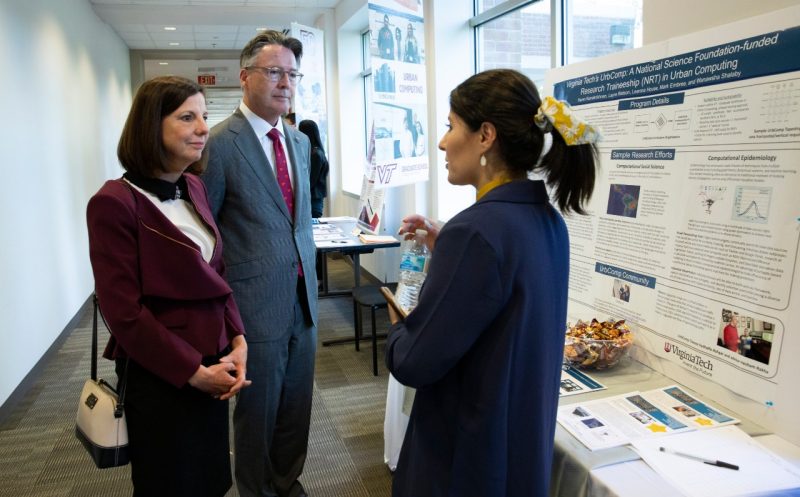 Dr. Laura Sands and President Tim Sands talk with a student during a tour of the Virginia Tech Northern Virginia Center in Falls Church