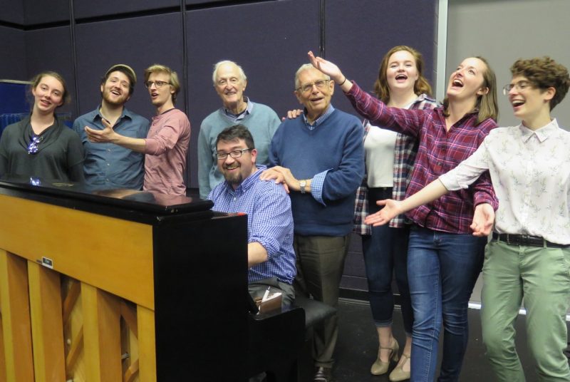 Students and community members rehearse a song from "The Sap of Life" around the piano with composer David Shire and lyricist Richard Maltby, Jr.