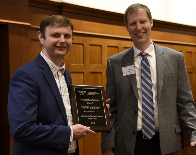 Dan Larimer (left) was recently presented with the Outstanding Alumnus Award by Cal Ribbens, department head, at the Department of Computer Science annual banquet.