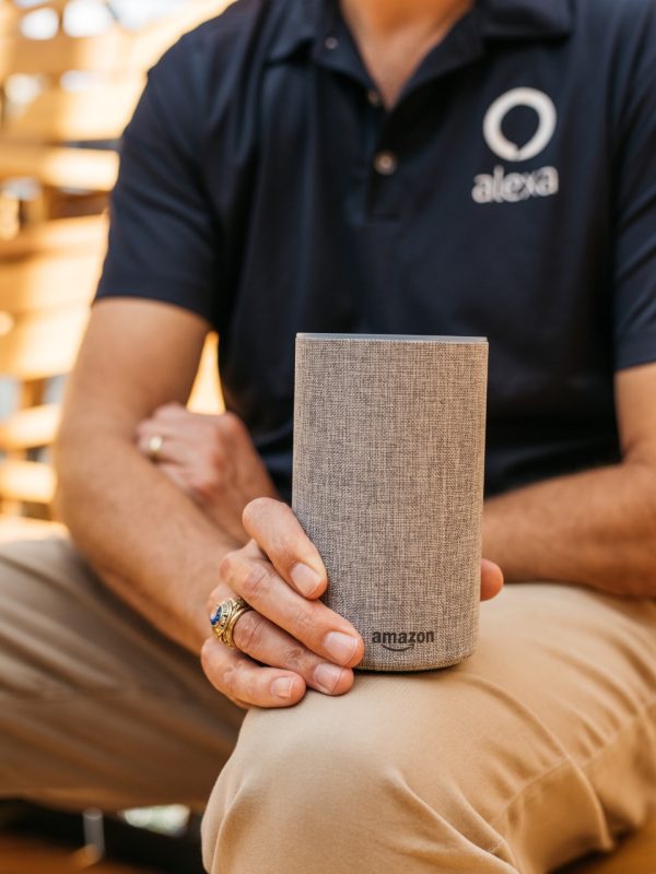 Virginia Tech graduate, Tom Taylor, holds an Amazon Echo speaker that allows people to connect with Alexa, a virtual assistant developed by the online retailer.