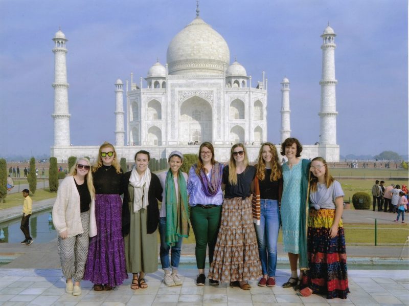 Students on the India and Social Justice study abroad program stand in front of the Taj Mahal.