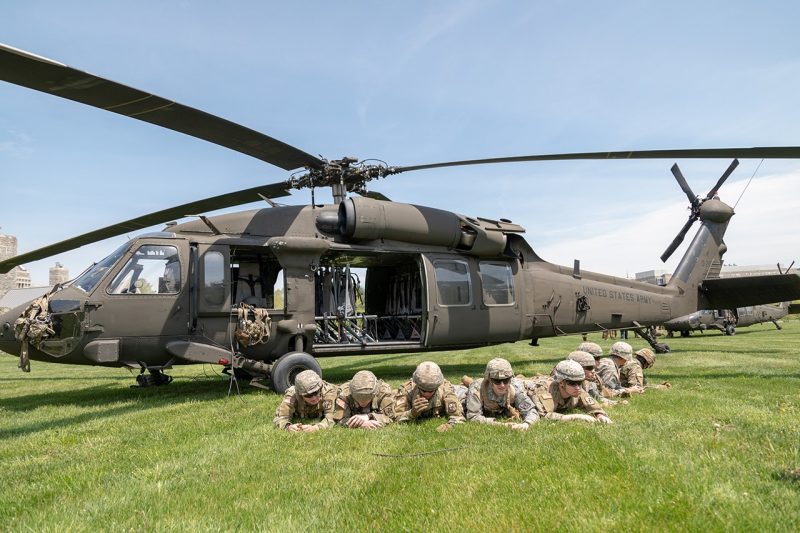 Cadets lay in front of a helicopter