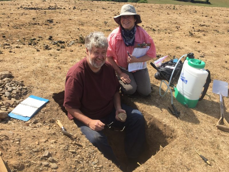 Lee Daniels and his wife, Jody Booze-Daniels are shown digging a small pit away from the mound to try to locate natural soil in order to provide the archeologists with a reference to the soil layers revealed in the mound excavation site. 